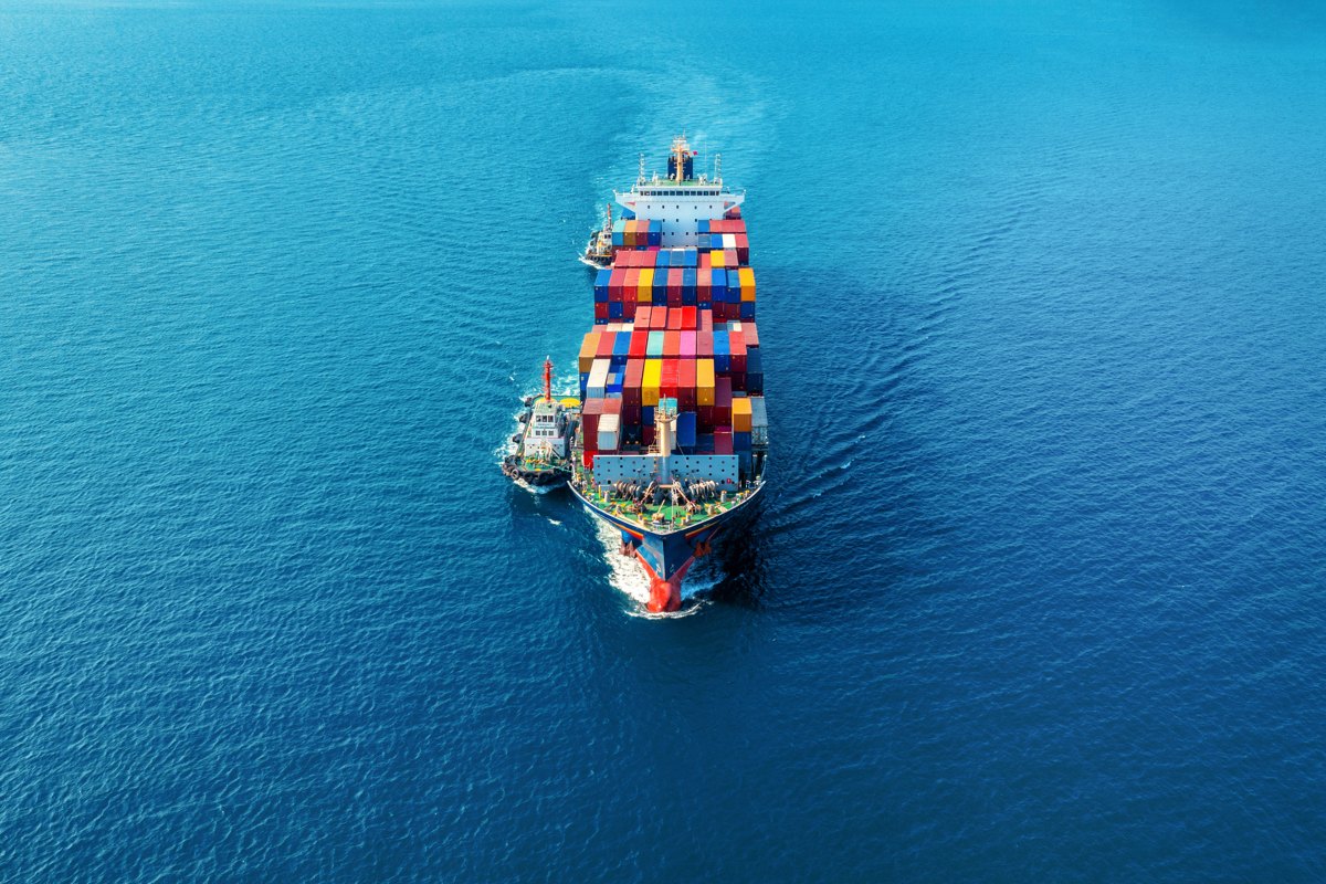 Container ship moving across open water.