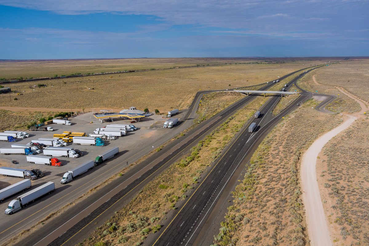 Horizontal panorama trucks stop on rest area near interstate highway in desert arizona usa