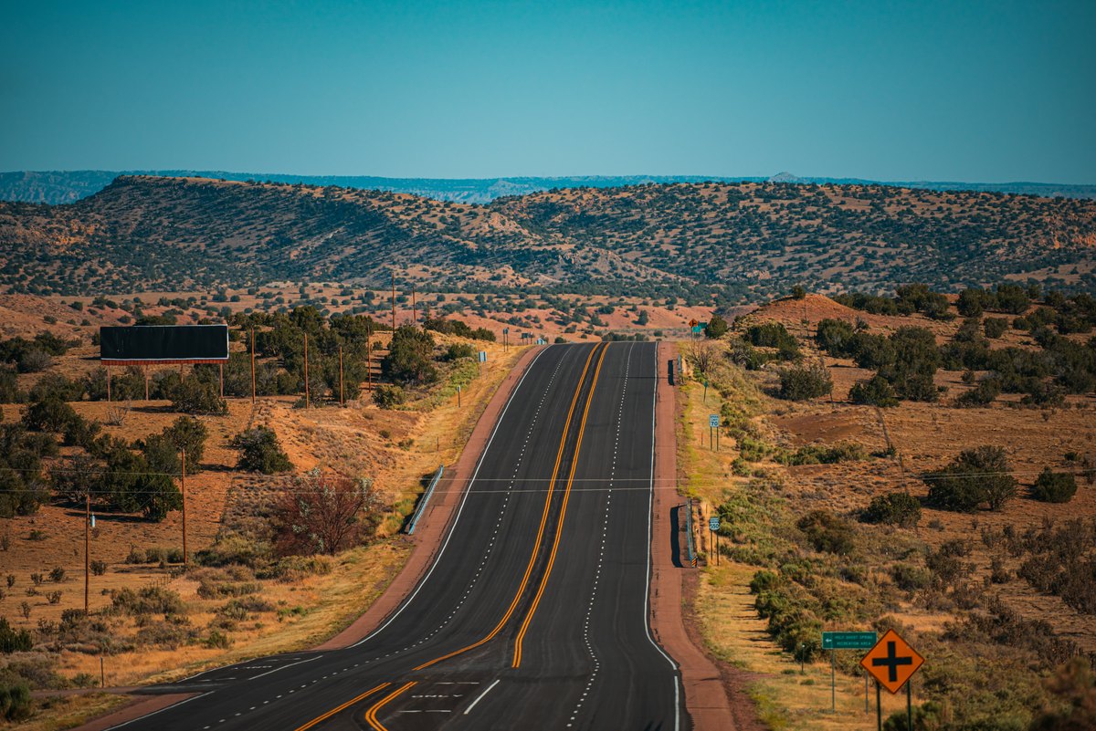 Long highway crossing California desert terrain