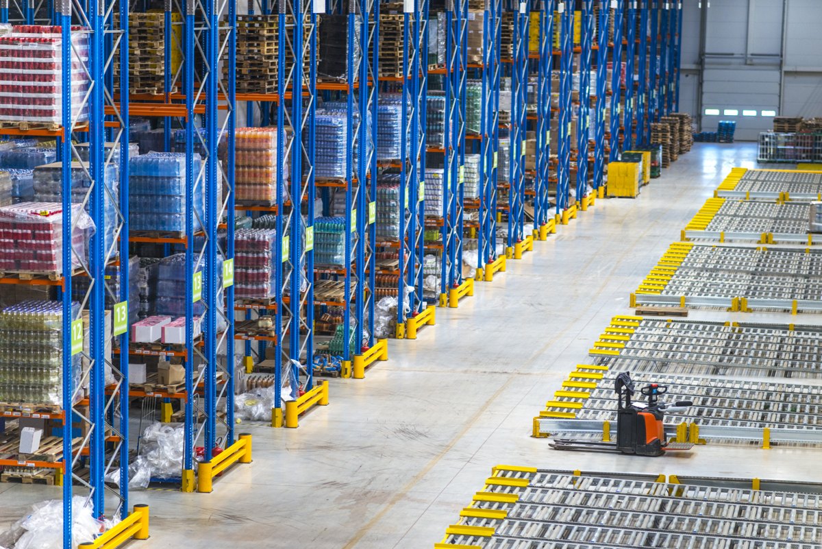 Warehouse aisles with pallet racks and a forklift.